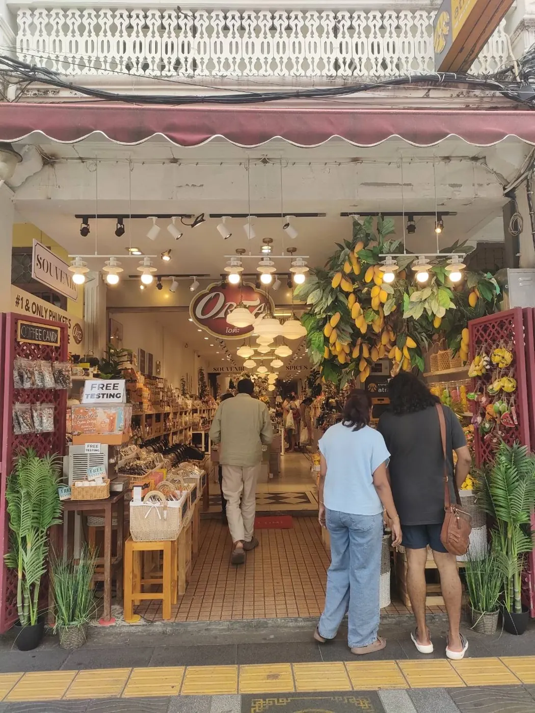 Shoppers walking into ORTA in Phuket Old Town